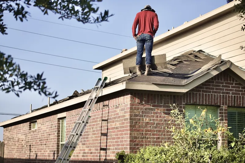 Professional roofer working on a residential roof in Kempner